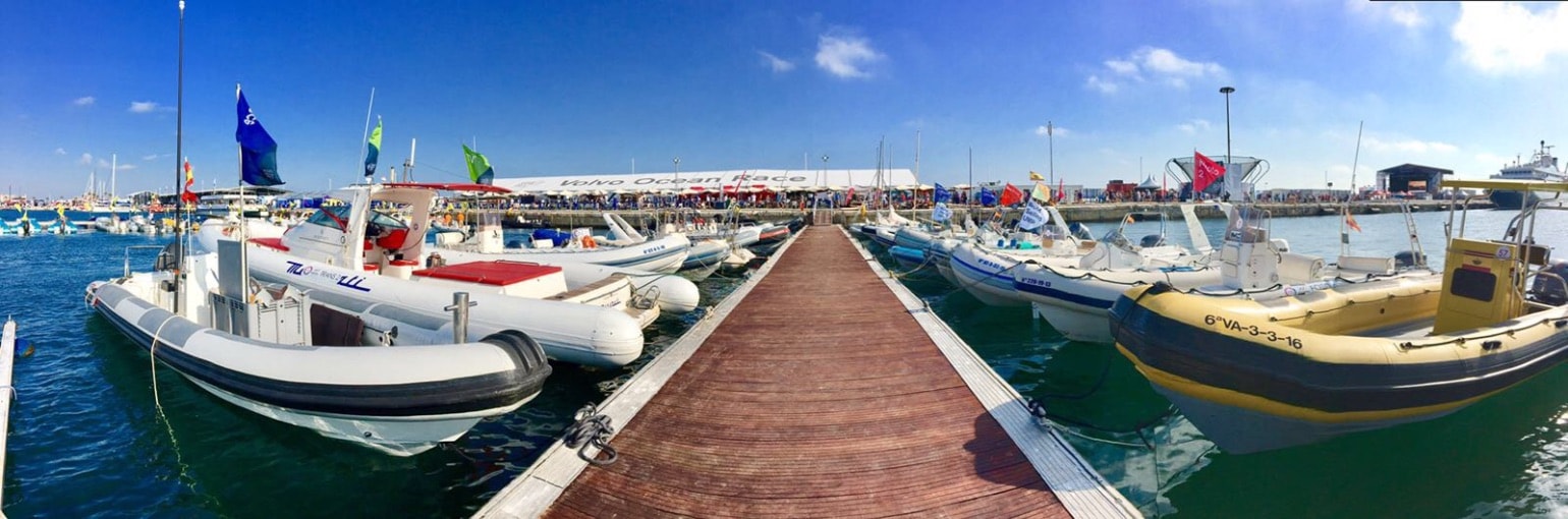 RIB fleet docked at a major sailing event village